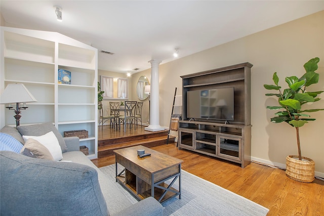 4241 Buena Vista St Unit 14, Dallas, TX 75205 - living area featuring wood finished floors, decorative columns, baseboards, and visible vents