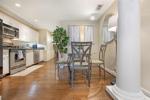 4241 Buena Vista St Unit 14, Dallas, TX 75205 - kitchen featuring white cabinets, visible vents, recessed lighting, appliances with stainless steel finishes, and wood finished floors