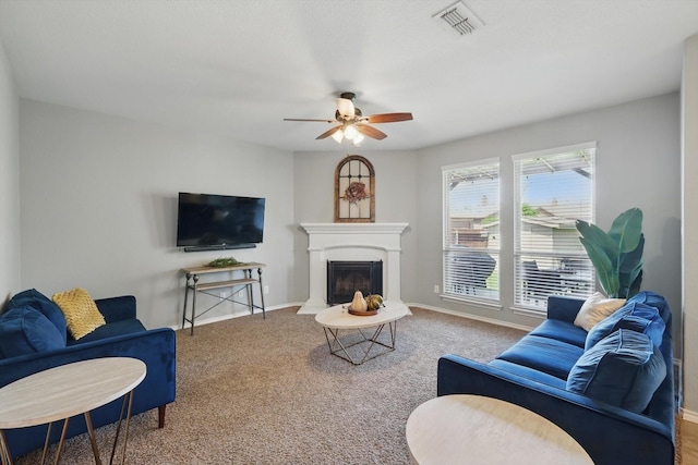 336 Avila Ln, Fort Worth, TX 76052 - living area featuring carpet floors, ceiling fan, and a fireplace with raised hearth