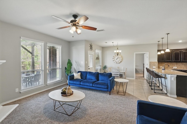 336 Avila Ln, Fort Worth, TX 76052 - living room with light colored carpet, a ceiling fan, light tile patterned floors, and a chandelier