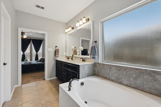 336 Avila Ln, Fort Worth, TX 76052 - ensuite bathroom featuring a bath, double vanity, tile patterned flooring, and a ceiling fan