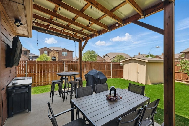 336 Avila Ln, Fort Worth, TX 76052 - fenced backyard with a patio, a storage unit, a grill, outdoor dining area, and a residential view