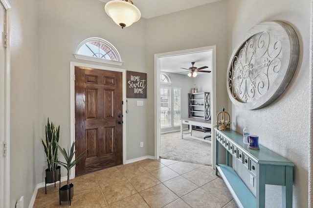 336 Avila Ln, Fort Worth, TX 76052 - entrance foyer featuring plenty of natural light, light tile patterned flooring, a ceiling fan, and light carpet