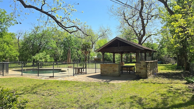 view of home's community with a gazebo, fence, a patio, and a lawn