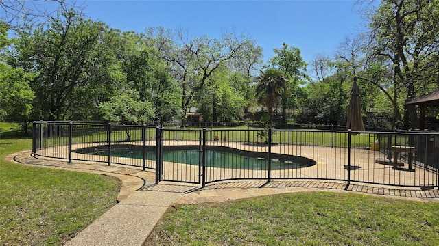 view of swimming pool with a fenced in pool, a yard, a patio area, and fence