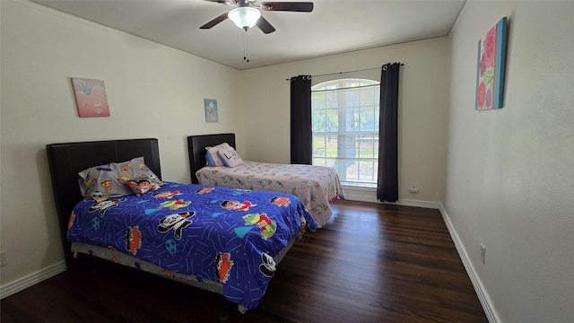 bedroom with baseboards, a ceiling fan, and wood finished floors