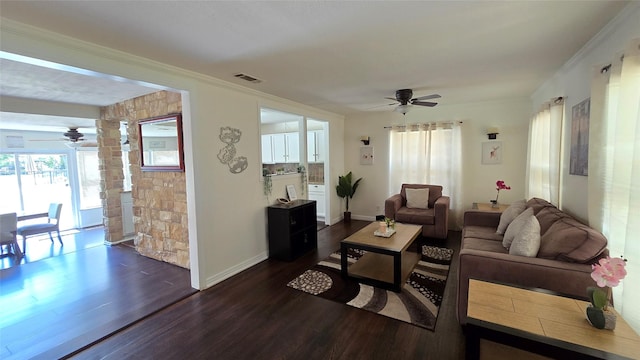living room featuring dark wood-type flooring, ceiling fan, and visible vents