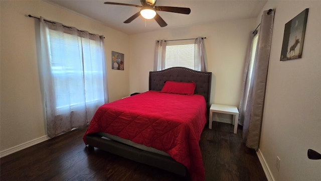 bedroom featuring ceiling fan, baseboards, and wood finished floors