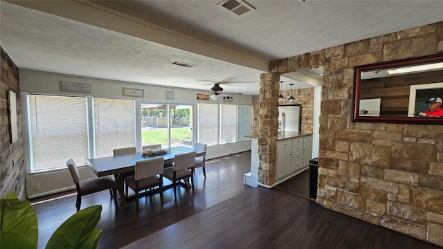 dining space with visible vents, a ceiling fan, and dark wood-style floors