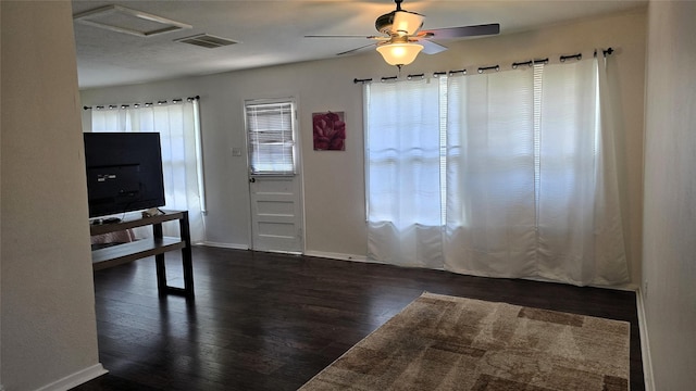 unfurnished room featuring wood finished floors, ceiling fan, baseboards, and visible vents