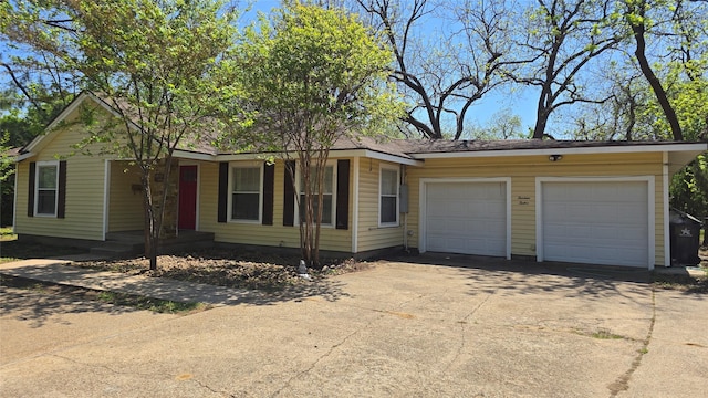 ranch-style house featuring driveway and a garage