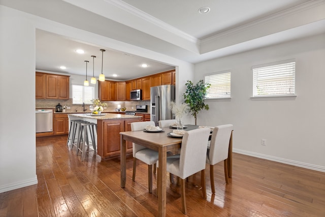 3194 Full Sail Ln, Frisco, TX 75036 - dining area with dark wood finished floors, recessed lighting, ornamental molding, baseboards, and a tray ceiling