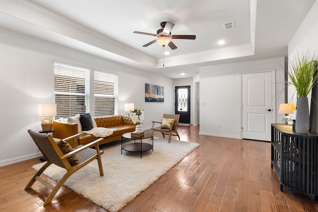 3194 Full Sail Ln, Frisco, TX 75036 - living room featuring a raised ceiling, ceiling fan, hardwood / wood-style flooring, baseboards, and ornamental molding