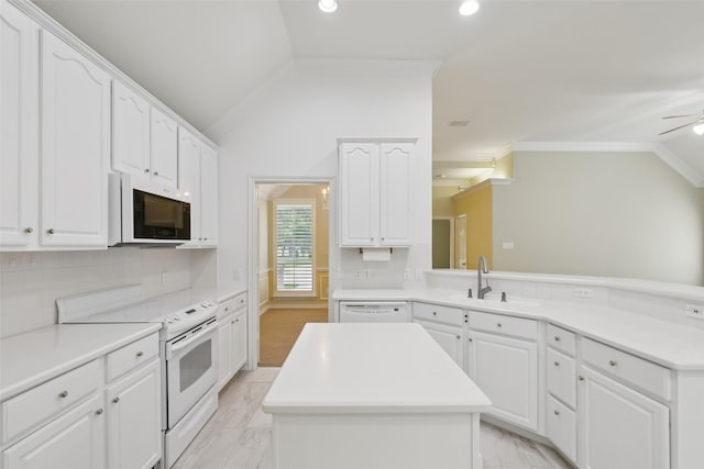 8425 Catskill Ct, Plano, TX 75025 - kitchen with white appliances, vaulted ceiling, a kitchen island, a sink, and ornamental molding