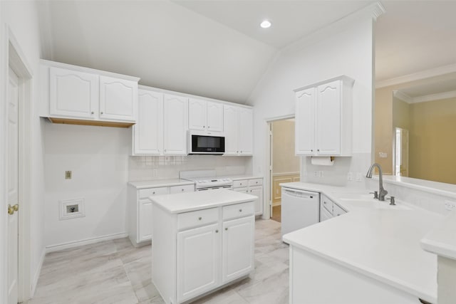 8425 Catskill Ct, Plano, TX 75025 - kitchen featuring white appliances, a sink, a peninsula, white cabinetry, and a center island