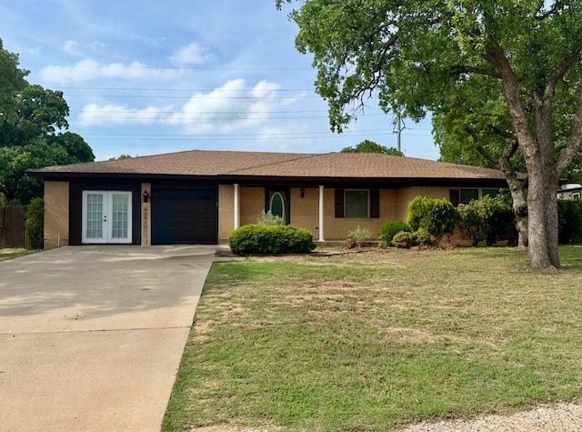 ranch-style house with fence, a garage, french doors, a front lawn, and concrete driveway