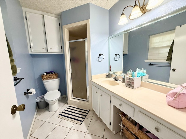 full bathroom with a textured ceiling, a stall shower, toilet, vanity, and tile patterned flooring