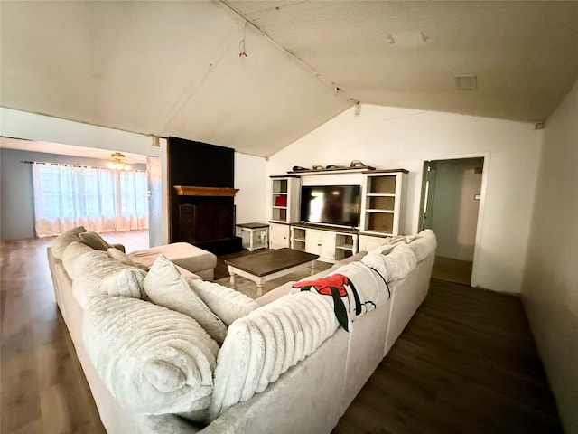 living area with wood finished floors and lofted ceiling