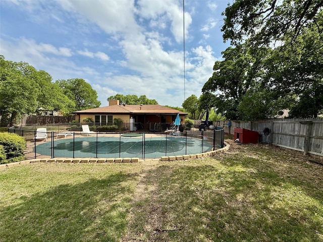 view of swimming pool with a fenced in pool, a yard, and a fenced backyard