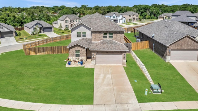 2112 Atlantic Ave, Anna, TX 75409 - traditional-style house with a front yard, fence, a residential view, driveway, and roof with shingles