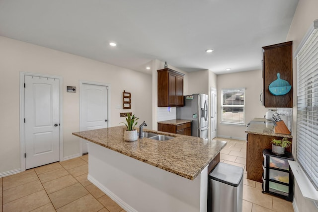 2112 Atlantic Ave, Anna, TX 75409 - kitchen featuring light tile patterned floors, a sink, light stone counters, and stainless steel fridge