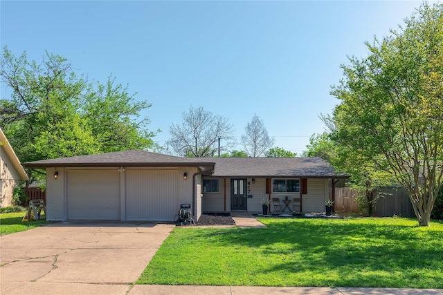 ranch-style home featuring concrete driveway and an attached garage