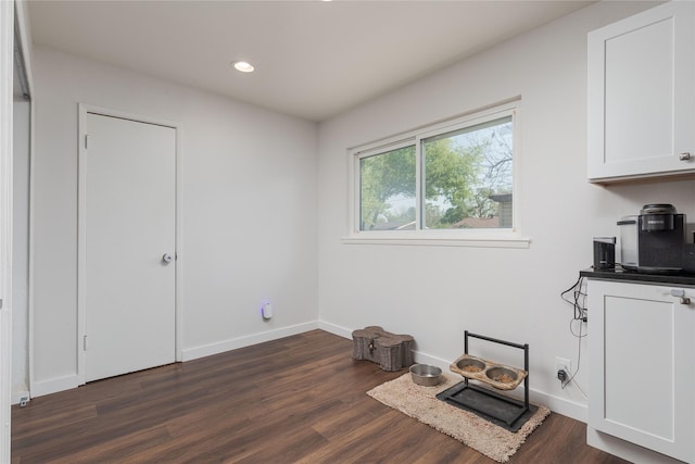 interior space with dark wood finished floors, recessed lighting, and baseboards