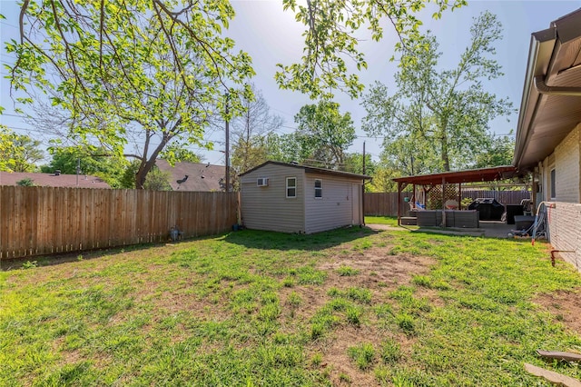 view of yard featuring an outdoor hangout area, an outbuilding, and a patio area