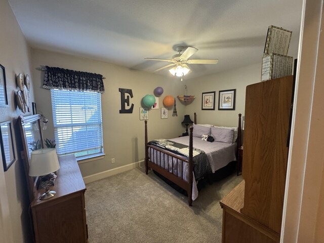 carpeted bedroom with baseboards and a ceiling fan