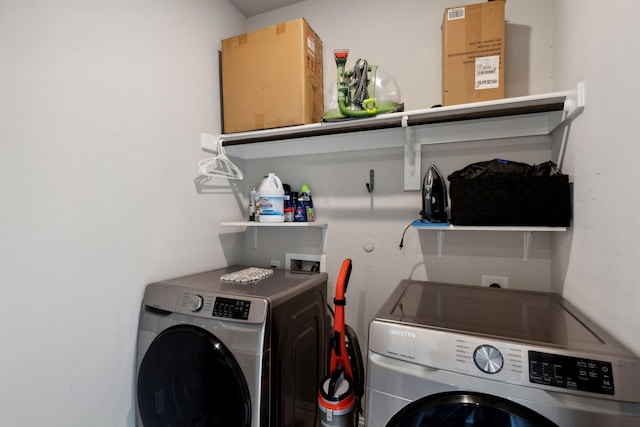 clothes washing area featuring laundry area and washing machine and dryer