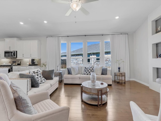 living room featuring ceiling fan, recessed lighting, and wood finished floors