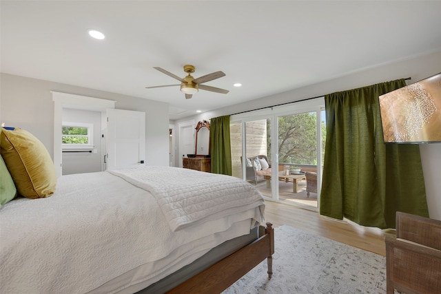 bedroom with recessed lighting, light wood-style flooring, access to exterior, and multiple windows