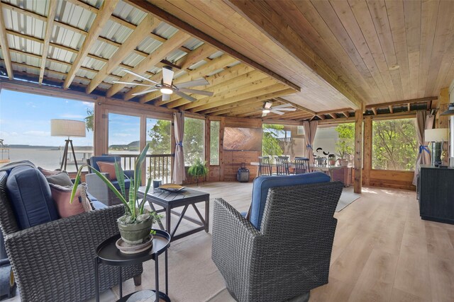 exterior space with a deck with water view and a ceiling fan