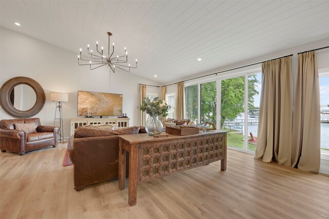 living room with recessed lighting, vaulted ceiling, light wood-type flooring, and an inviting chandelier