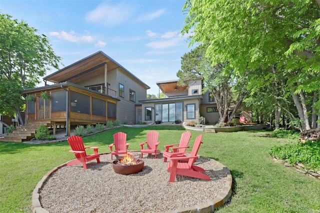 exterior space with a fire pit and a sunroom