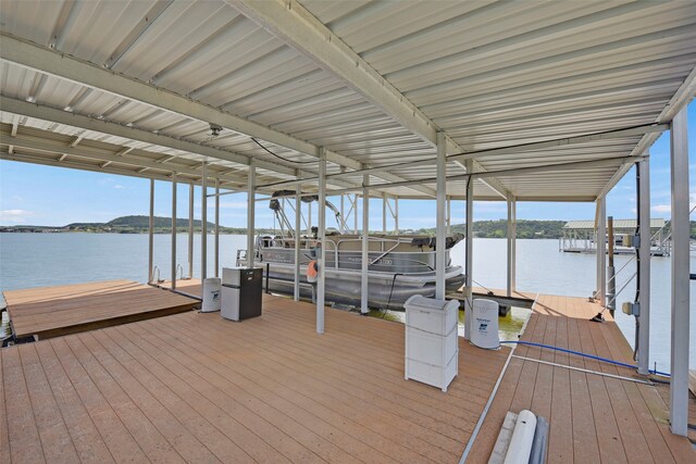 dock area with boat lift and a water view