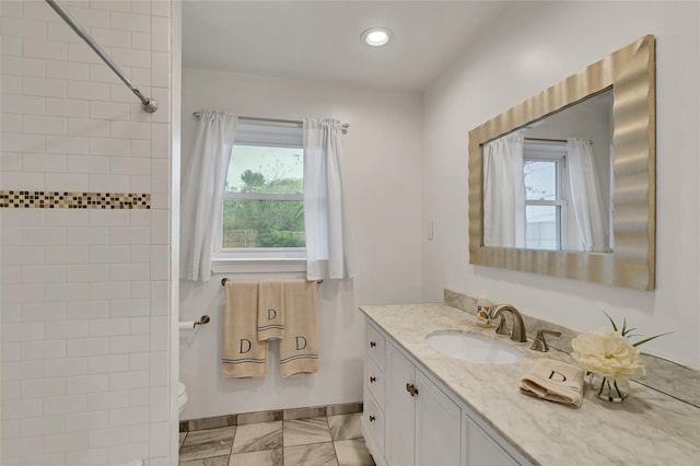 bathroom with vanity, baseboards, recessed lighting, toilet, and marble finish floor