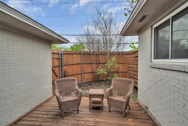 wooden deck featuring a fenced backyard