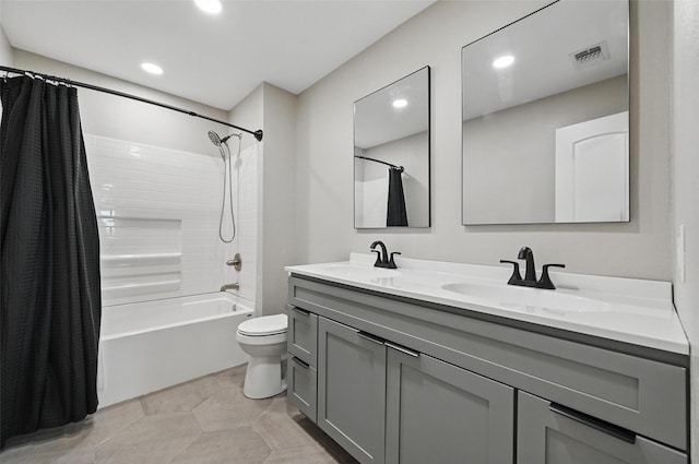 full bathroom with visible vents, a sink, double vanity, and toilet