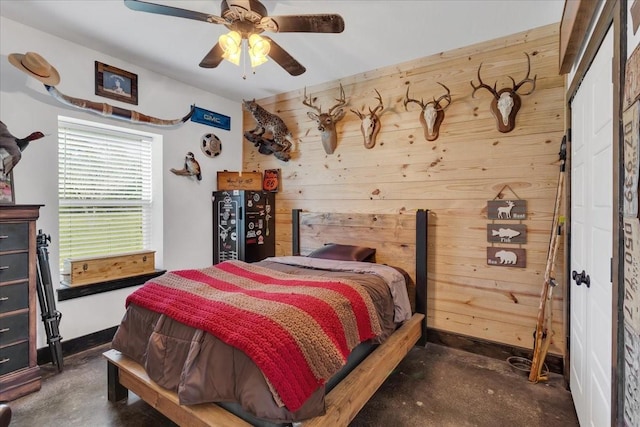 4024 County Road 2610, Bonham, TX 75418 - bedroom with wooden walls, concrete flooring, baseboards, and ceiling fan