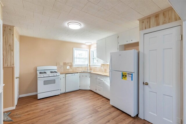 509 Reeves St, Clyde, TX 79510 - kitchen with tasteful backsplash, a sink, light wood-style floors, light countertops, and white appliances