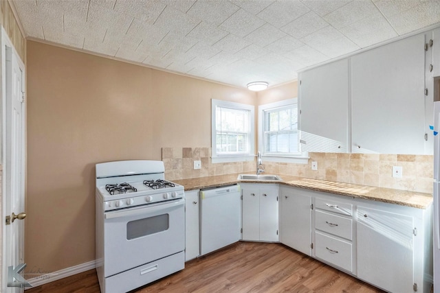 509 Reeves St, Clyde, TX 79510 - kitchen with light wood-type flooring, white appliances, backsplash, and a sink