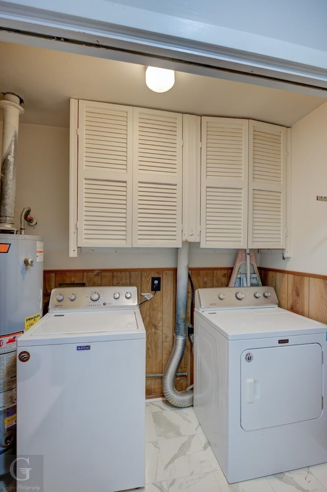 3132 Sandra Dr, Shreveport, LA 71119 - laundry area featuring gas water heater, wood walls, wainscoting, cabinet space, and marble finish floor