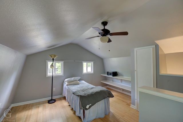 3132 Sandra Dr, Shreveport, LA 71119 - bedroom featuring lofted ceiling, baseboards, light wood-type flooring, a textured ceiling, and ceiling fan