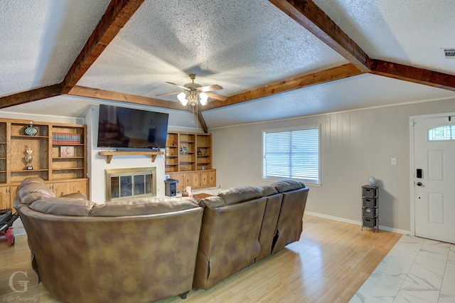 3132 Sandra Dr, Shreveport, LA 71119 - living area with beamed ceiling, a ceiling fan, visible vents, and a textured ceiling