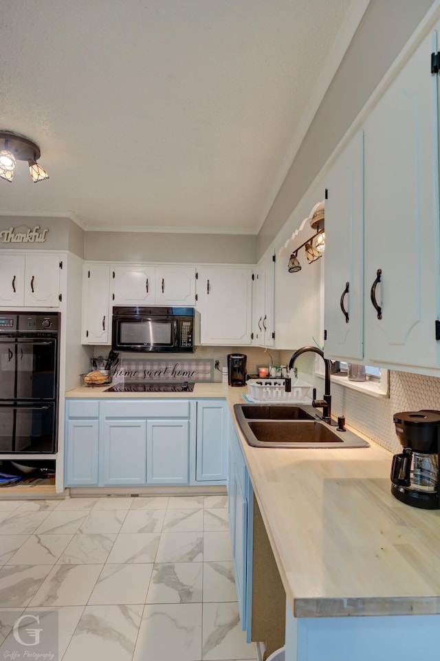 3132 Sandra Dr, Shreveport, LA 71119 - kitchen featuring a sink, light countertops, white cabinets, and black appliances