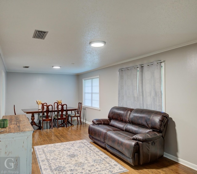 3132 Sandra Dr, Shreveport, LA 71119 - living area with light wood finished floors, visible vents, and crown molding