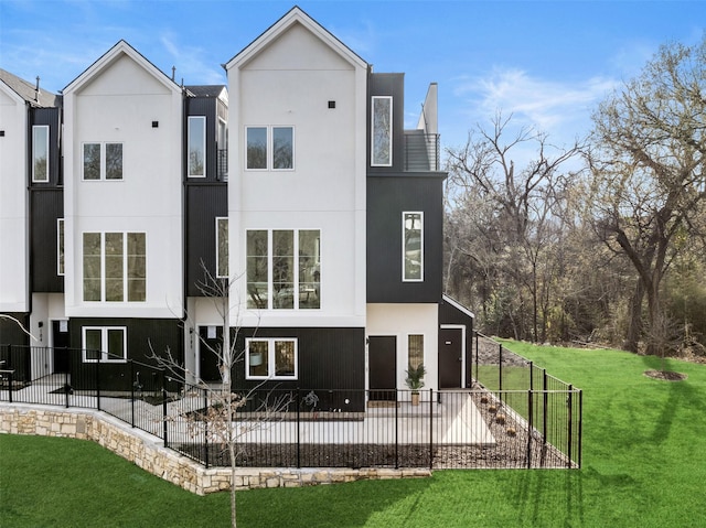rear view of house with a patio area and stucco siding