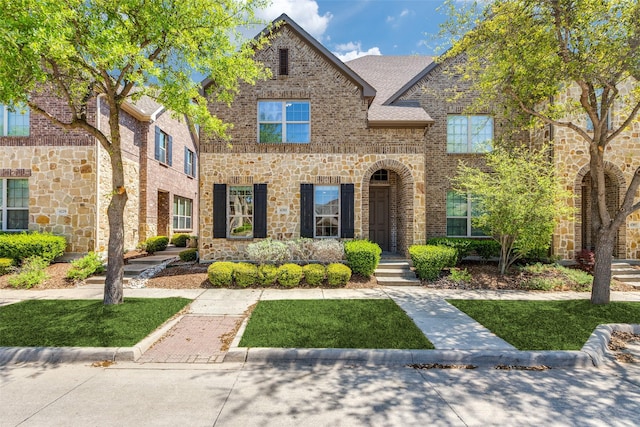4301 Blackjack Oak Dr, Mckinney, TX 75070 - view of front of house featuring brick siding, stone siding, and a front lawn