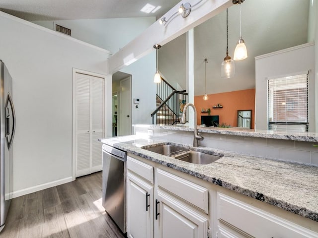 kitchen featuring dark wood-style flooring, visible vents, stainless steel appliances, pendant lighting, and a sink